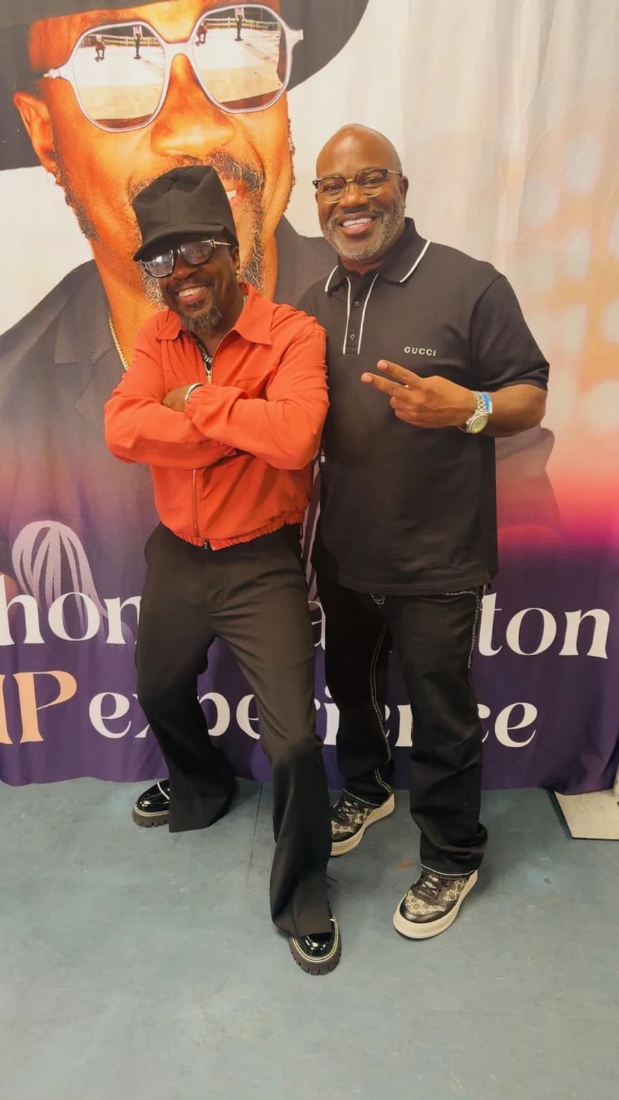 Posing in front of an Anthony Hamilton performance backdrop