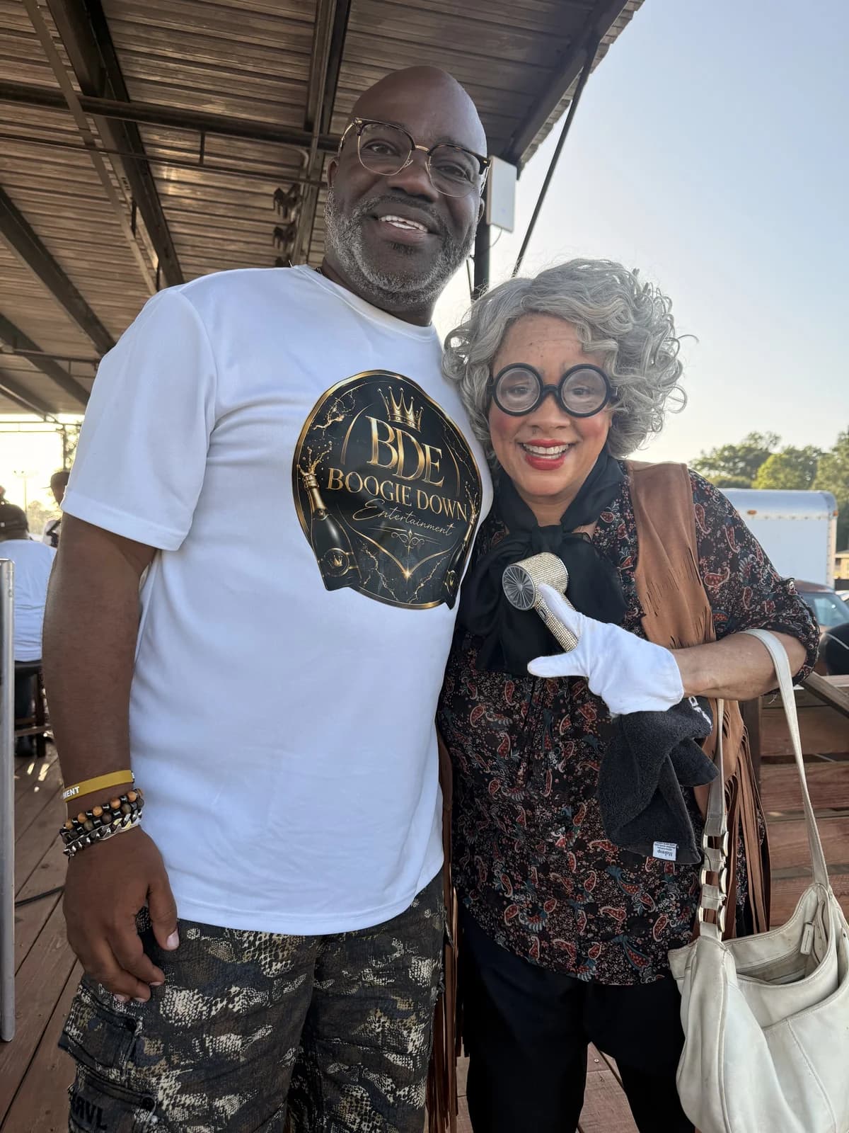 Marcus Banks posing with a costumed Madea character performer