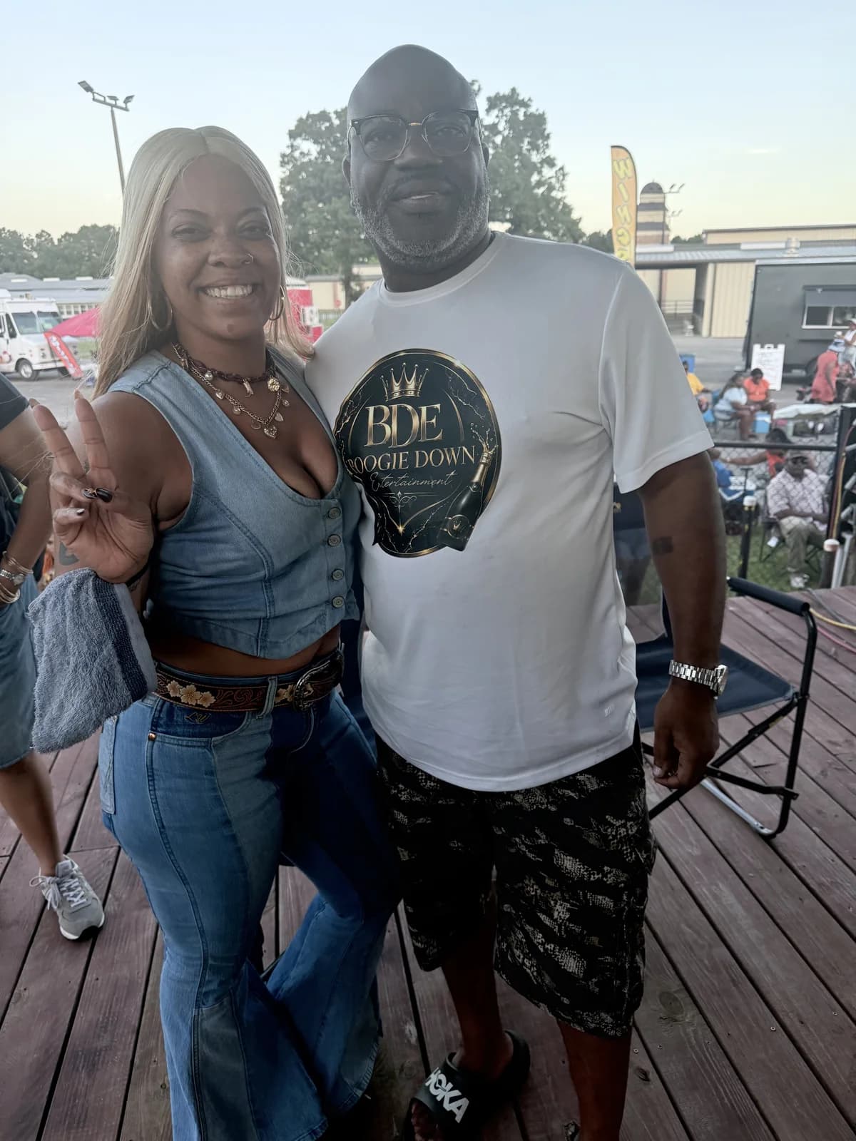 Marcus Banks posing with artist Cecily Wilburn outdoors at a festival